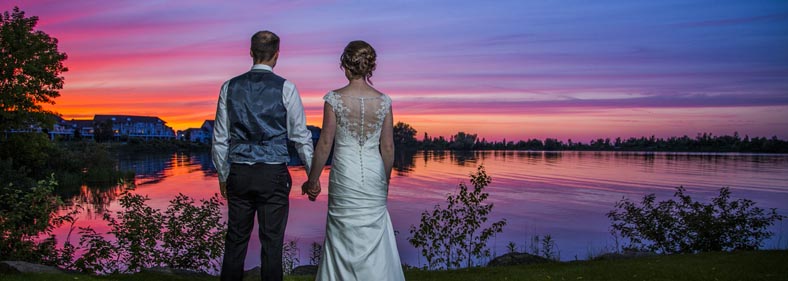 Vibrant colored sunset viewed by a newly wed couple by Chris Gardiner Photography www.cgardiner.ca